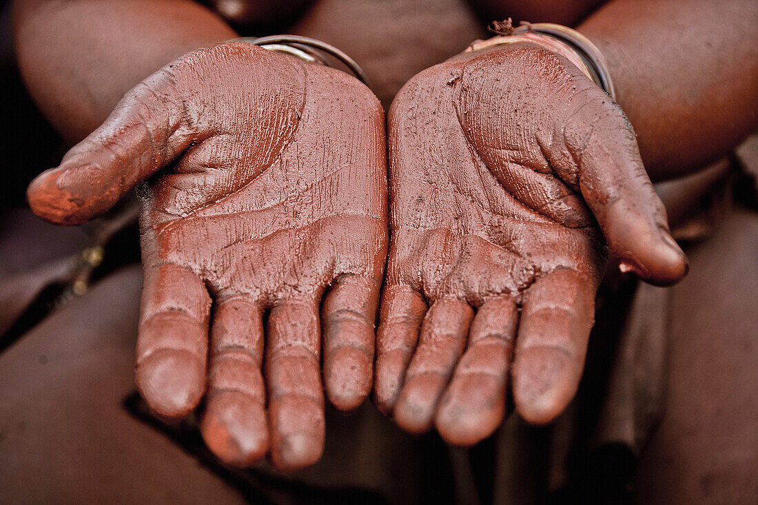 Hands of a woman from the Himba tribe with red paste, Kaokoland, Namibia, Africa