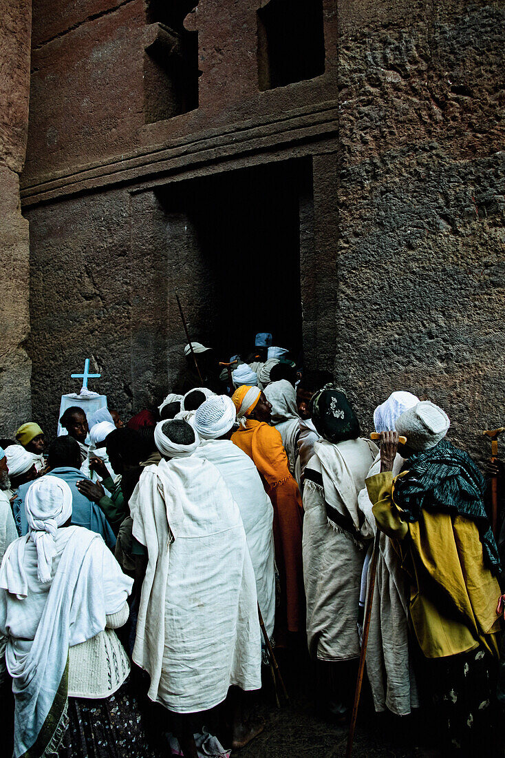 Pilger betreten eine Felsenkirche in Lalibela, Äthiopien, Afrika