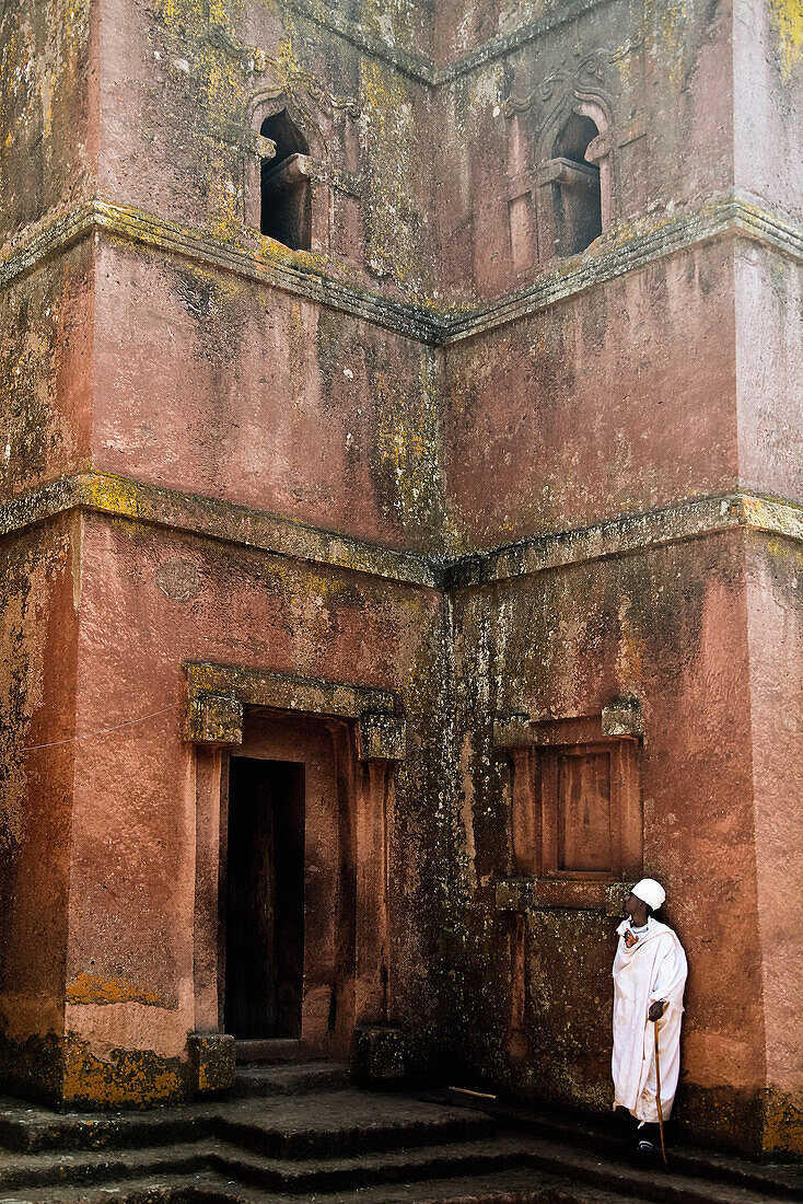 Ein Gläubiger steht vor der Felsenkirche des Heiligen Georg, Lalibela, Äthiopien, Afrika