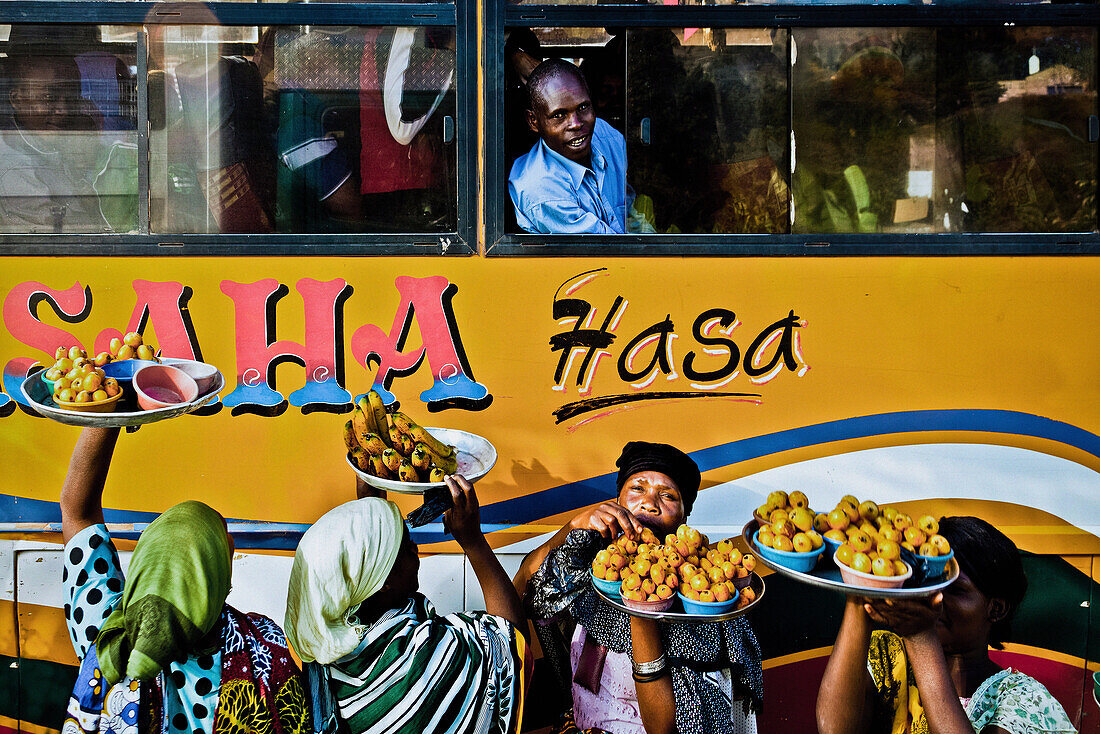 Women selling fruit to bus travellers, Tanzania, Africa