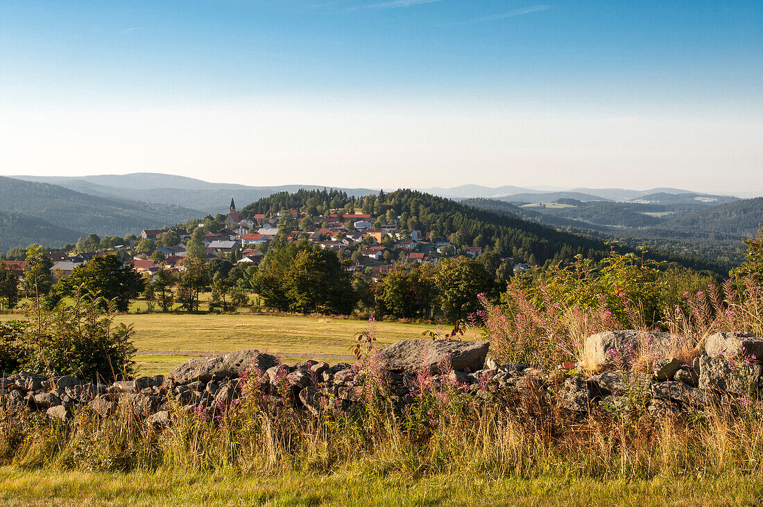 view across wall and fields towards Finsterau, Bavarian Forest, Bavaria, Germany