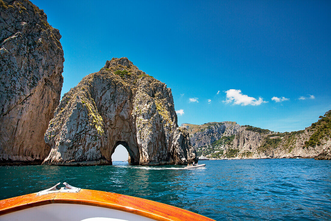 Boat at Faraglioni stacks, Capri, Bay of Naples, Campania, Italy