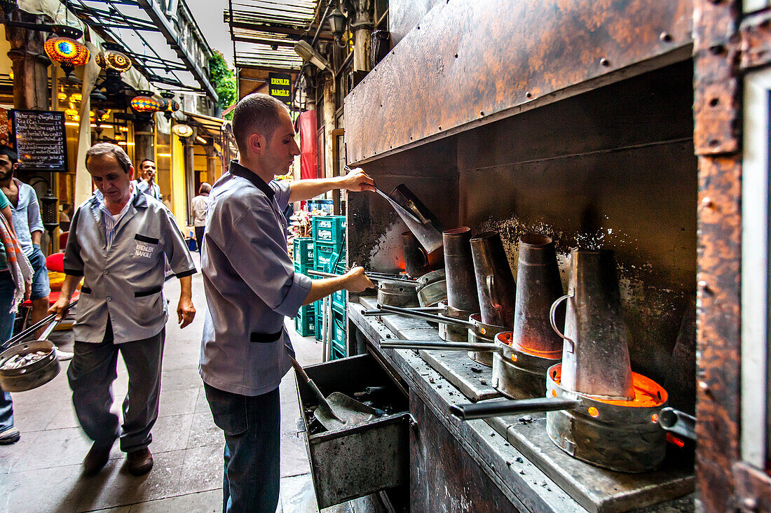 Man preparing coal for the hookahs in a teashop, Istanbul, Turkey
