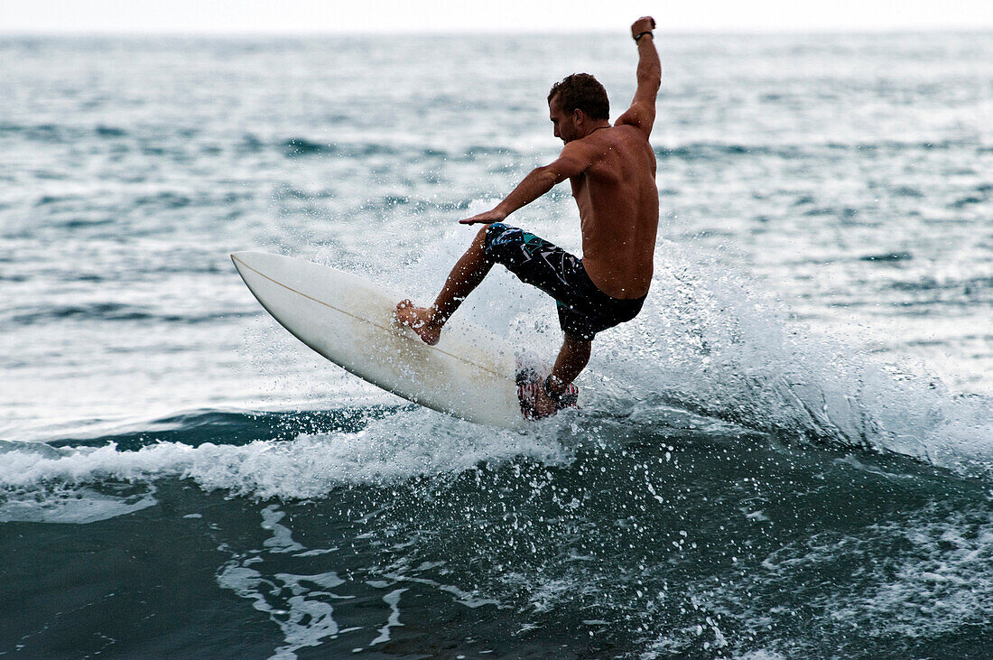 A young man surfing in Costa Rica, Dominical, Costa Rica