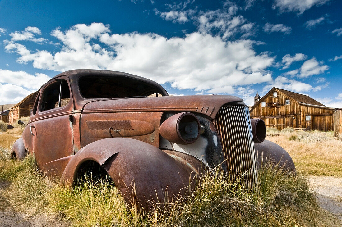 An old abandoned car rusts away in the ghost town of Bodie, CA Bodie, California, USA