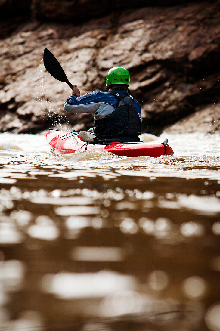 A middle age man paddles his whitewater kayak down the Salt River in Arizona AZ, USA