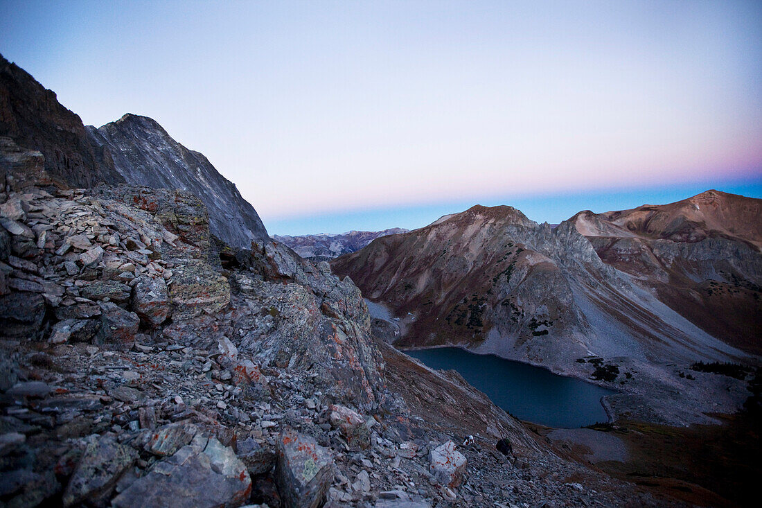 Two young men hiking at sunrise in the mountains Aspen, Colorado, USA