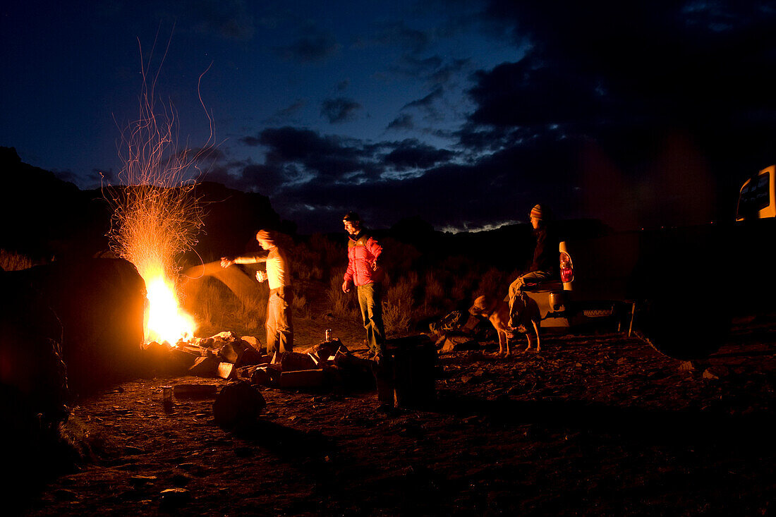 Three people and a dog hanging out around a campfire Spokane, Washington, United States