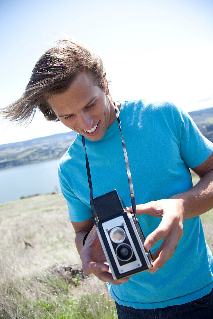 Man taking pictures with a vintage camera Hood River, Oregon, USA