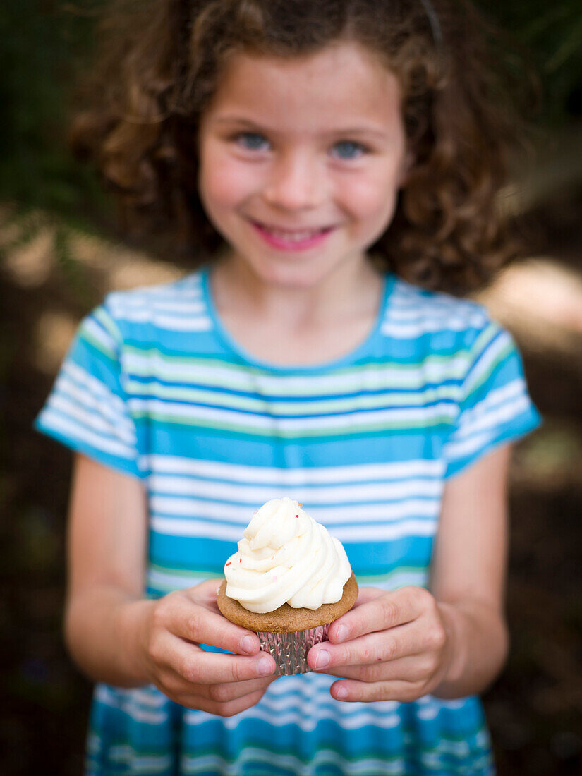 girl poses with cupcake, portland, me, usa