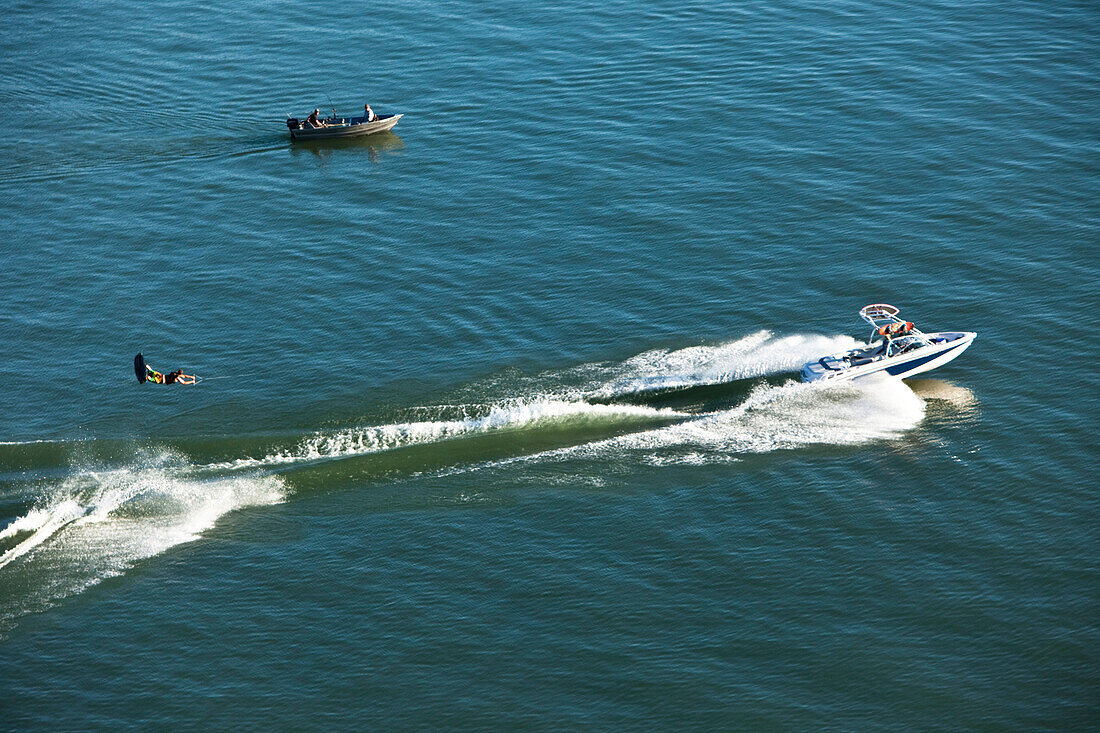 A athletic wakeboarder jumps the wake going huge on a calm day in Idaho Sandpoint, Idaho, USA