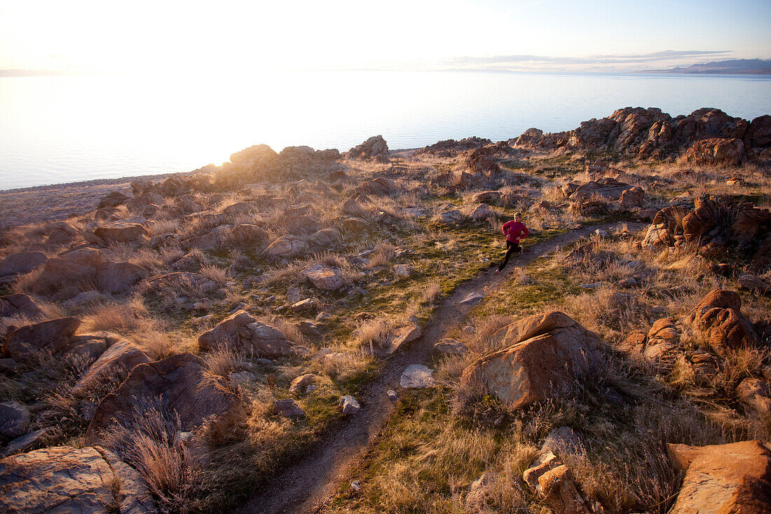 A woman out for an afternoon trail run on Antelope Island, Utah Utah, USA