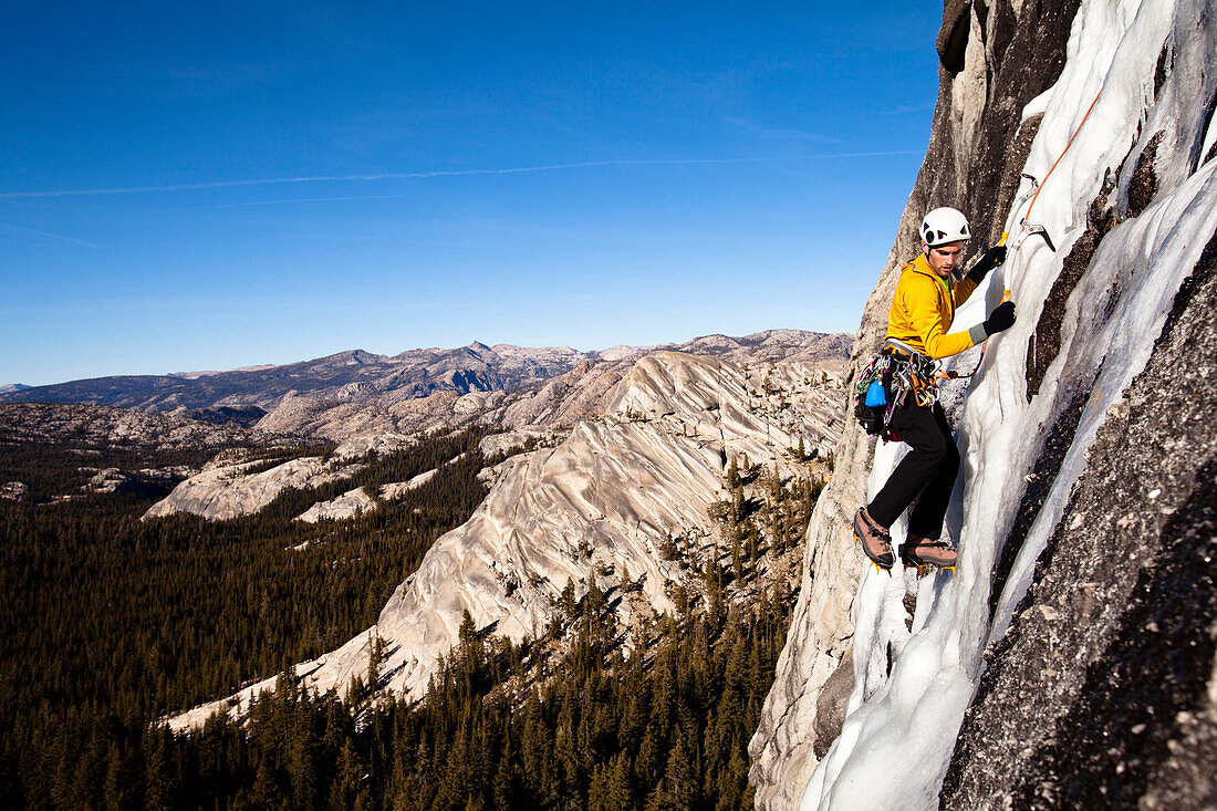 An ice climber climbs Yellow Brick Road (WI3+) on Drug Dome in Tuolumne Meadows located inside Yosemite National Park, California., Yosemite National Park, California, United States of America