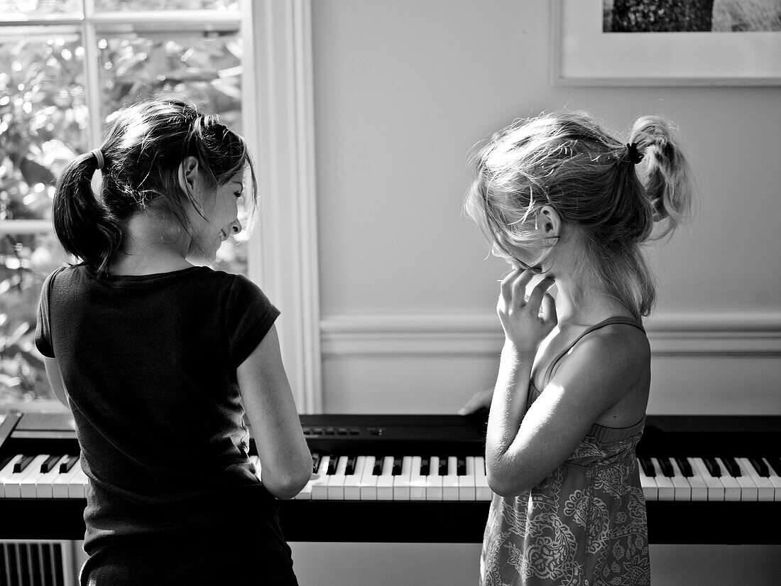 two friends practice the piano, portland, me, usa