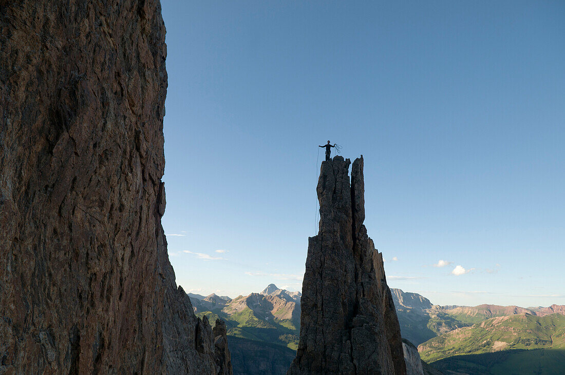A man standing on rock spire in the White River National Forest, Marble, Colorado(silhouette)., usa