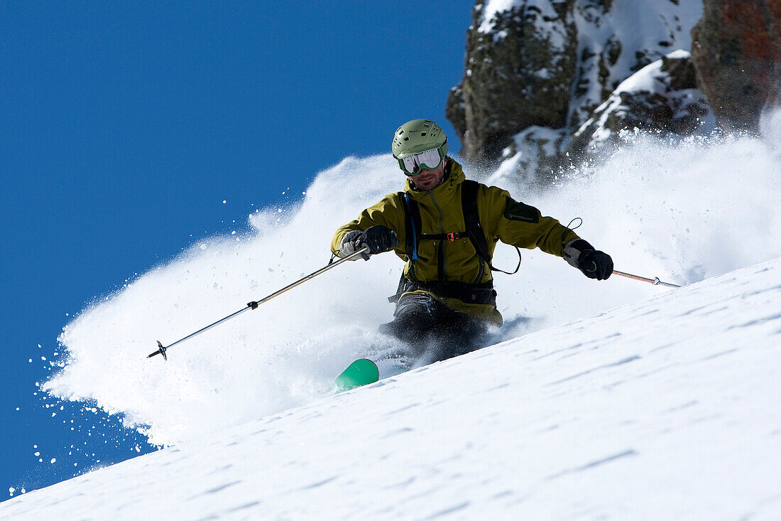 One skier making a hard turn in fresh powder., South Lake Tahoe, California, USA