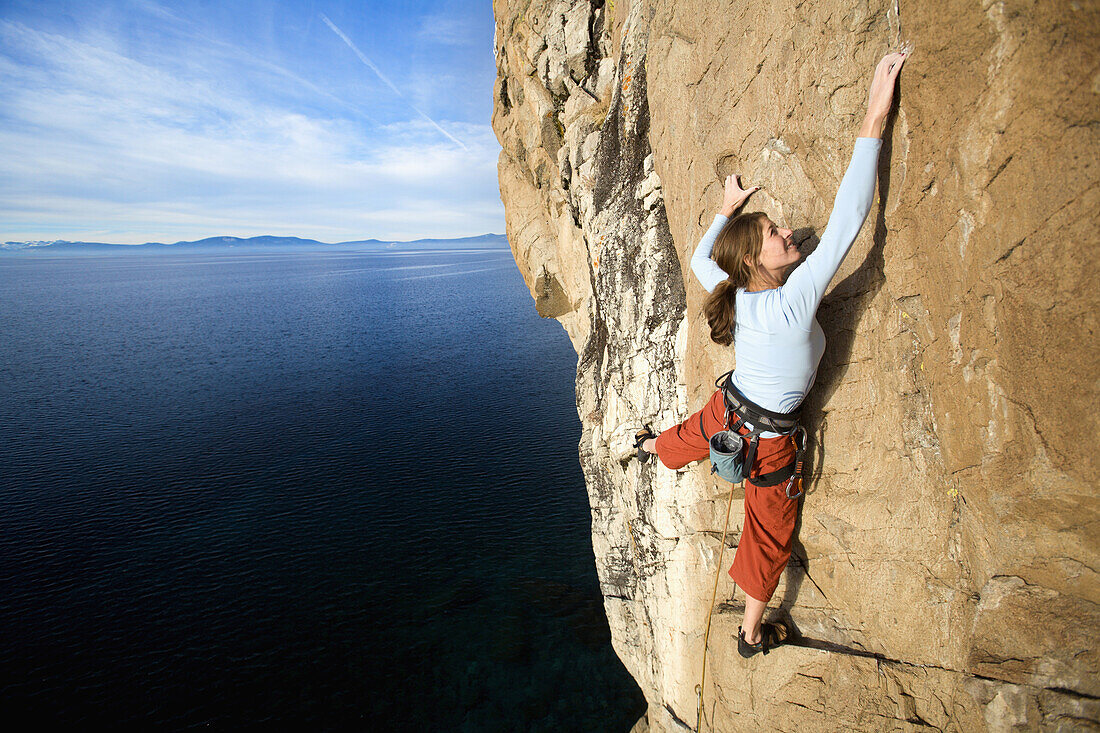 Climber grabs a hold while climbing Lake Tahoe, Nevada, United States
