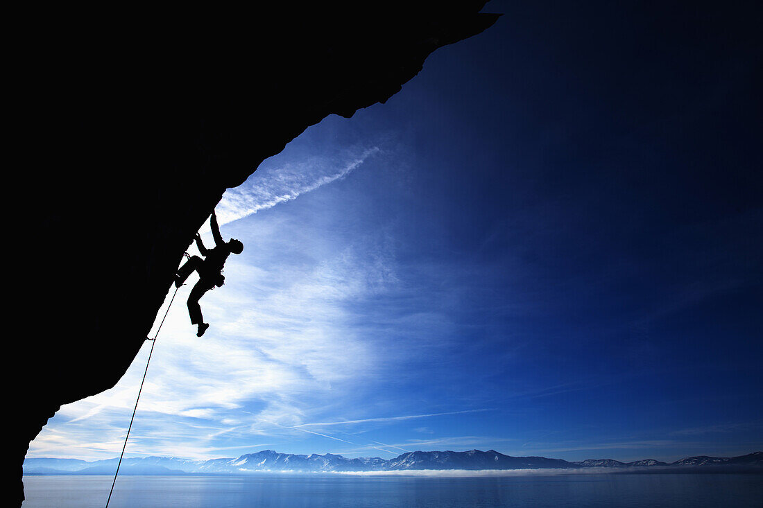 Man climbing against blue sky Lake Tahoe, Nevada, United States