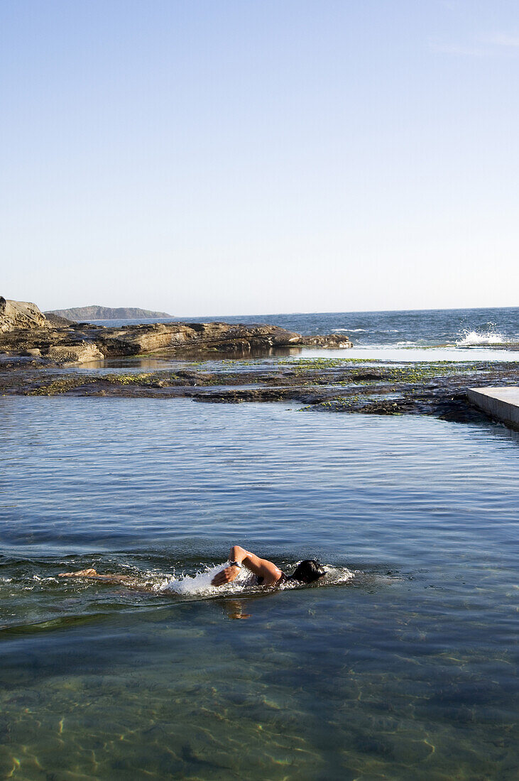 Man swims in ocean rock pool Sydney, New South Wales, Australia
