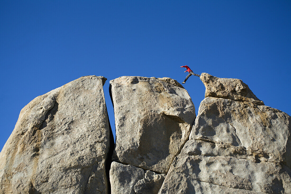 Climber jumping across a gap Bishop, California, United States