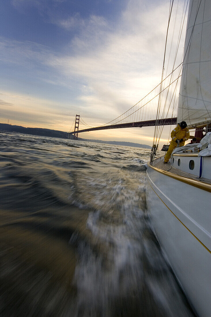 A man furls a sail on a yacht San Francisco, California, United States