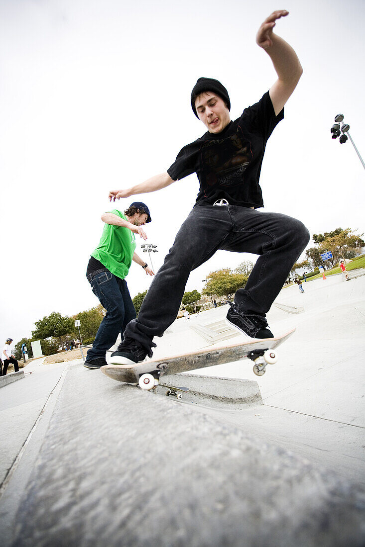 Two skateboarders do tricks at a skatepark Carlsbad, California, United States