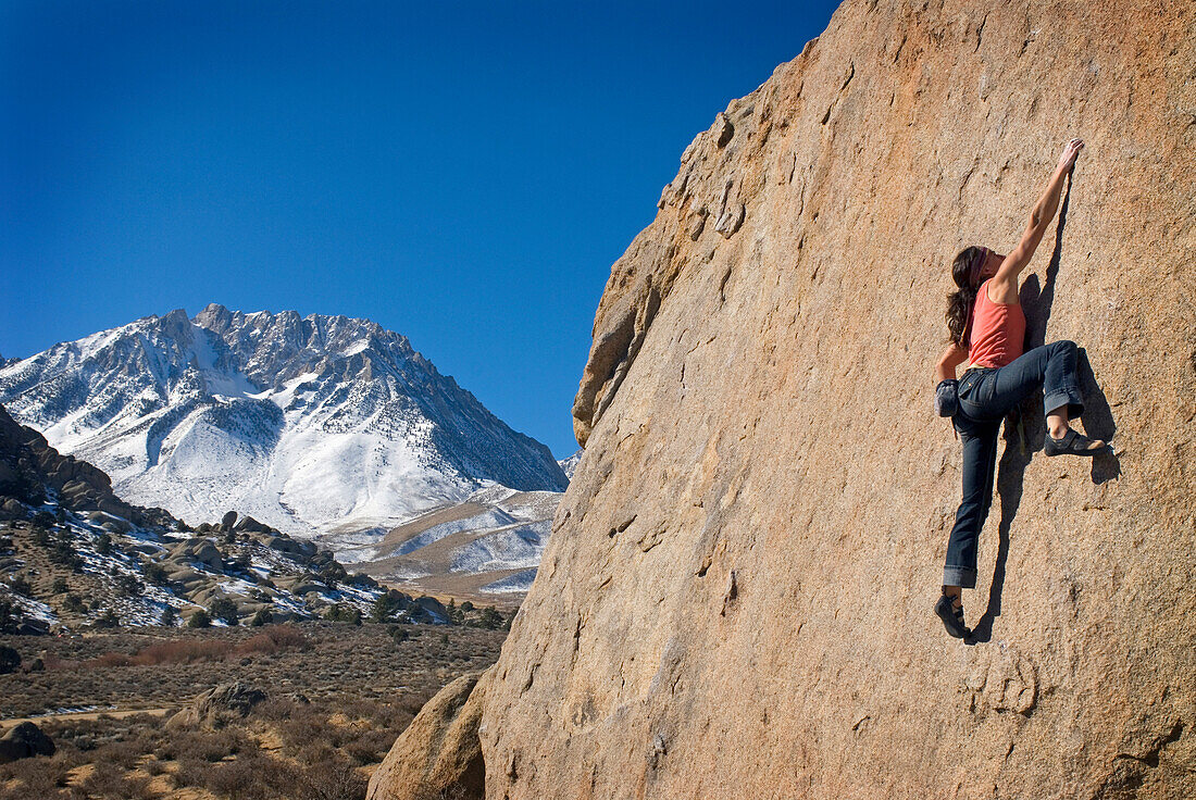 Young woman rock climbing at the Buttermilks near Bishop, California Bishop, California, USA