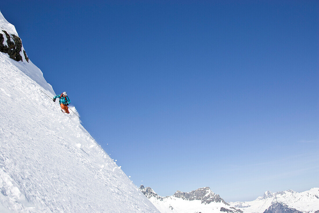A young man skis untracked powder off-piste at St. Anton am Arlberg, Austria St. Anton am Arlberg, Arlberg, Austria
