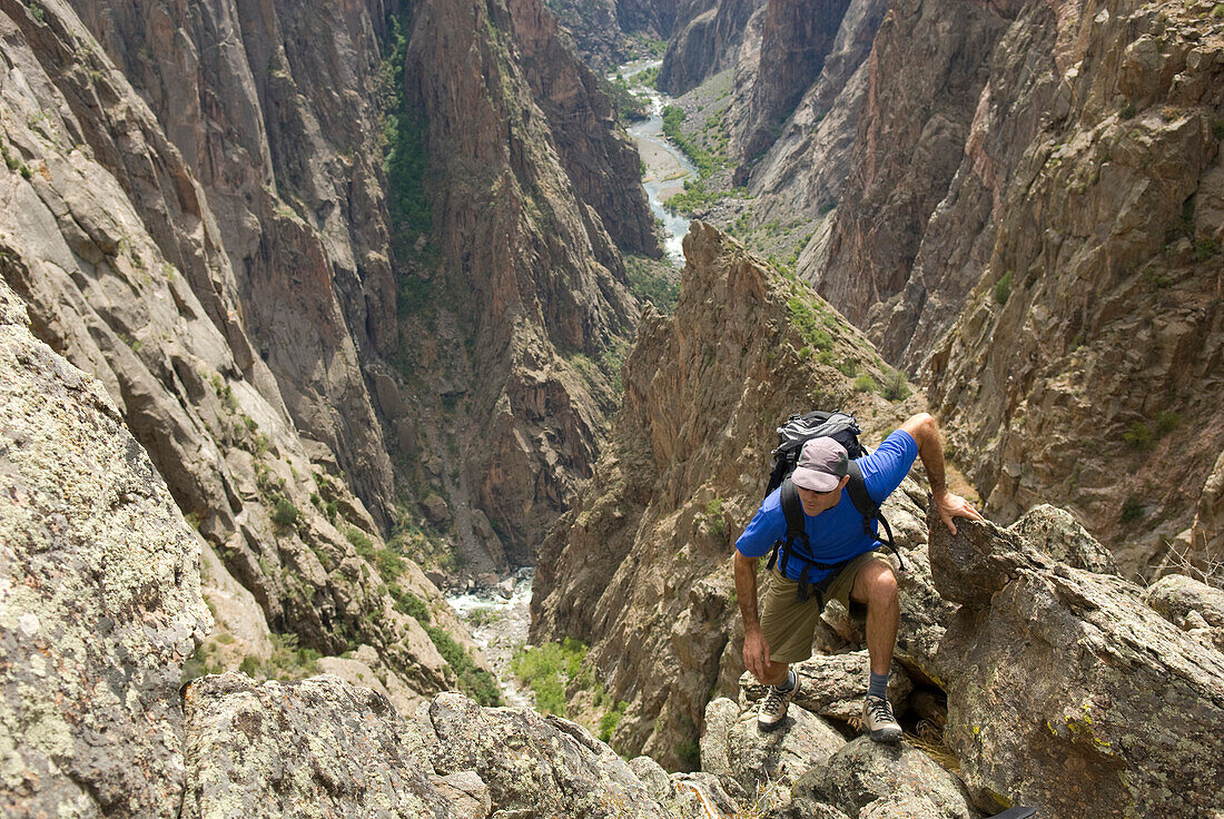 Man hiking on the North Rim of the Black Canyon of the Gunnison, Colorado Crawford, Colorado, USA