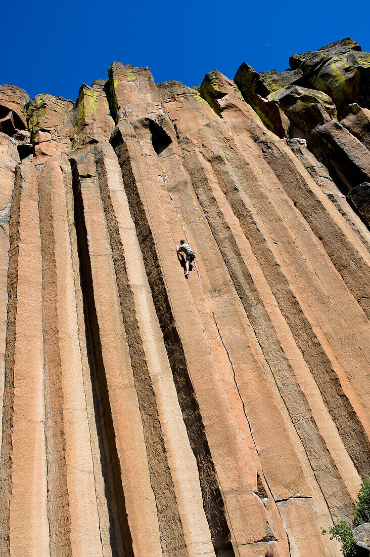 A mid adult man rock climbing at Trout Creek, Oregon Madras, Oregon, USA