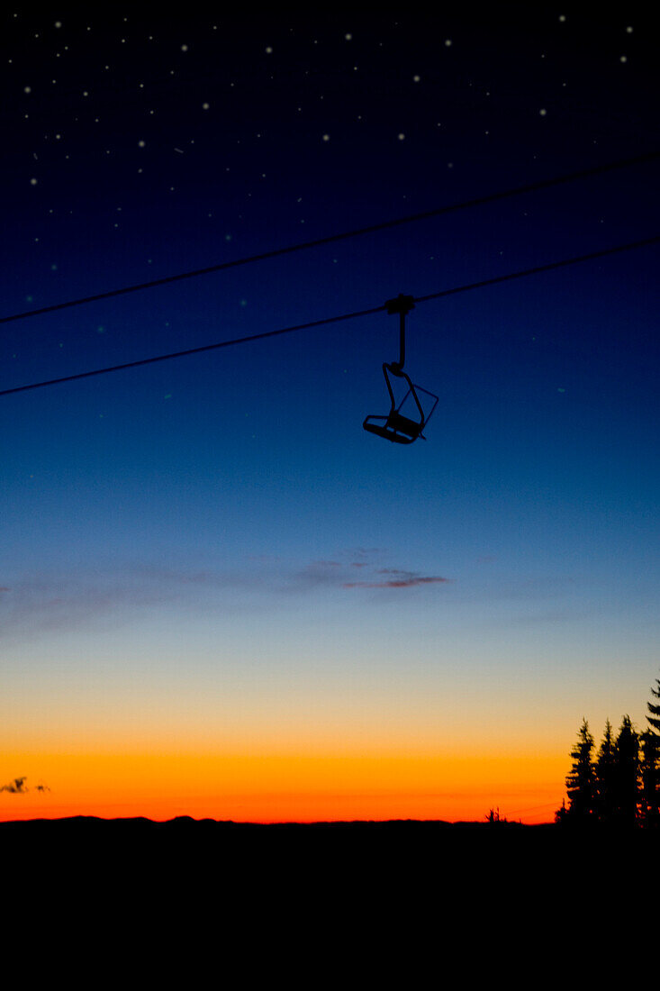 A ski lift in front of a blue and orange sunset Oregon, USA
