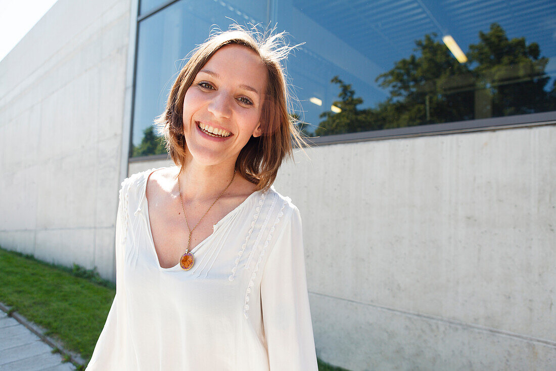 Mid adult woman smiling at camera, Munich, Bavaria, Germany