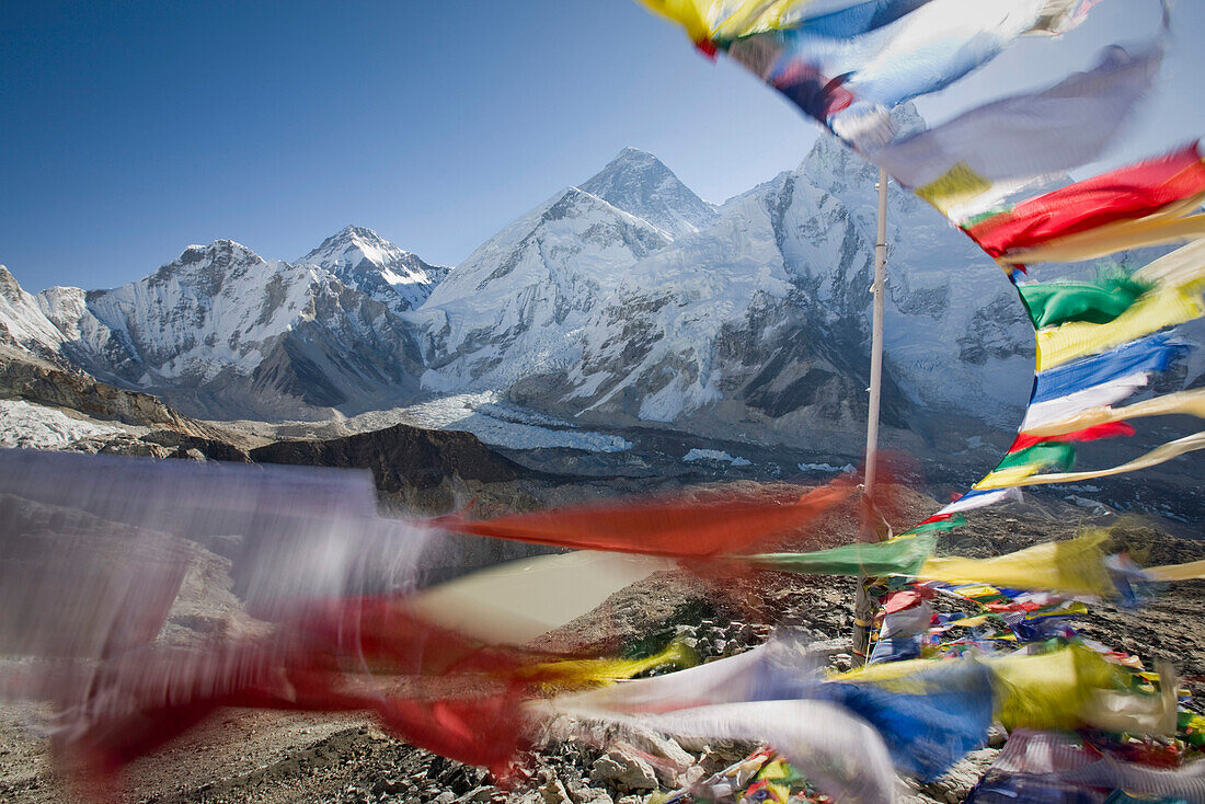 Prayer flags streaming in the wind frame a view of Mt. Everest, Khumbu Glacier, Nepal Khumbu, Nepal