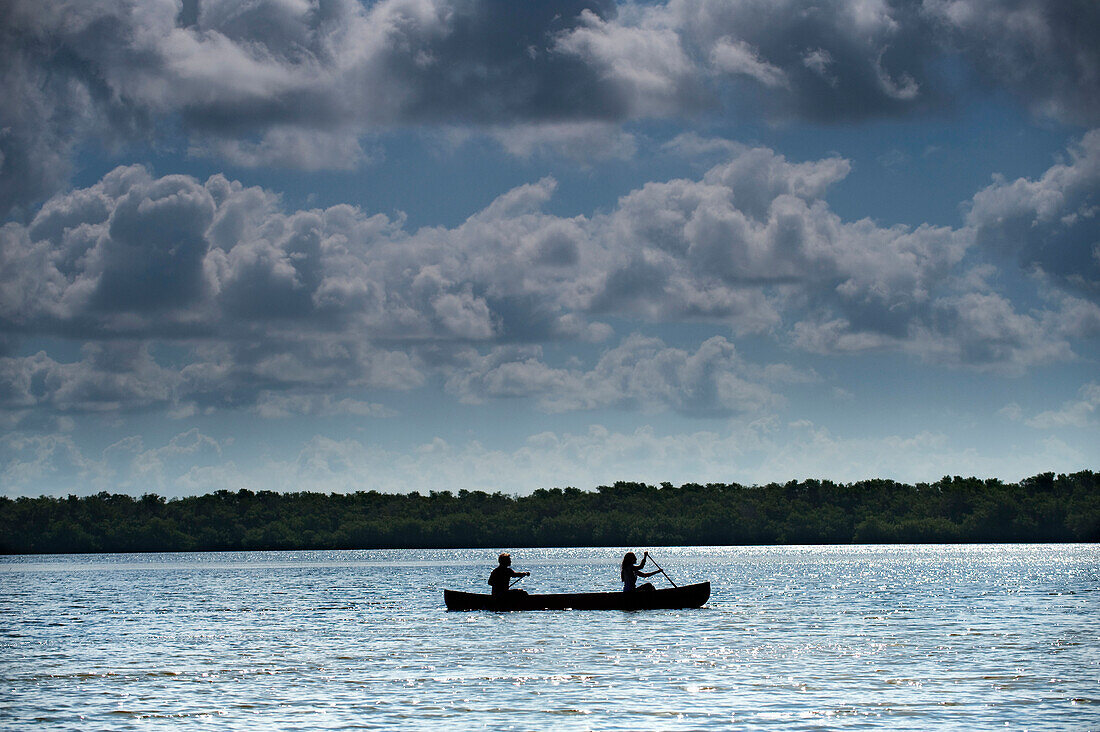 A couple paddles a canoe in Everglades National Park, Florida Florida, USA