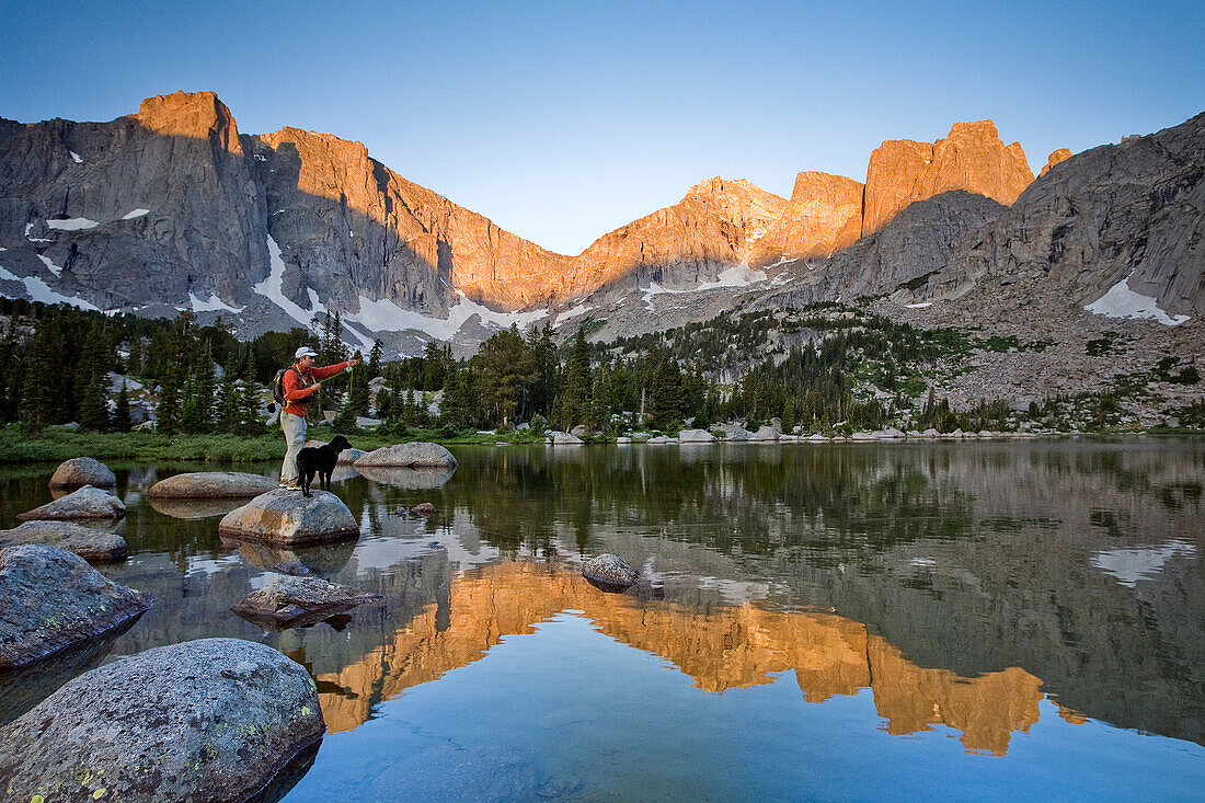 A male fly fisherman in a lake below the Cirque of the Towers, Wind River Range, Wyoming Wyoming, USA