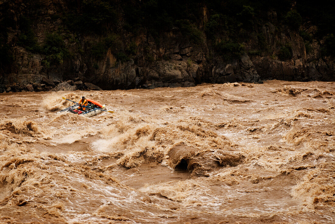 Rubber raft running rapids during a whitewater rafting trip to Western China China