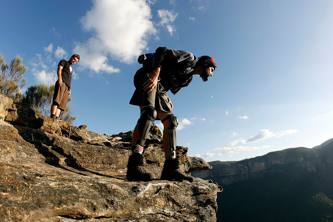 A BASE jumper checks conditions before leaping off a cliff in the Blue Mountains, New South Wales, Australia Blue Mountains, New South Wales, Australia
