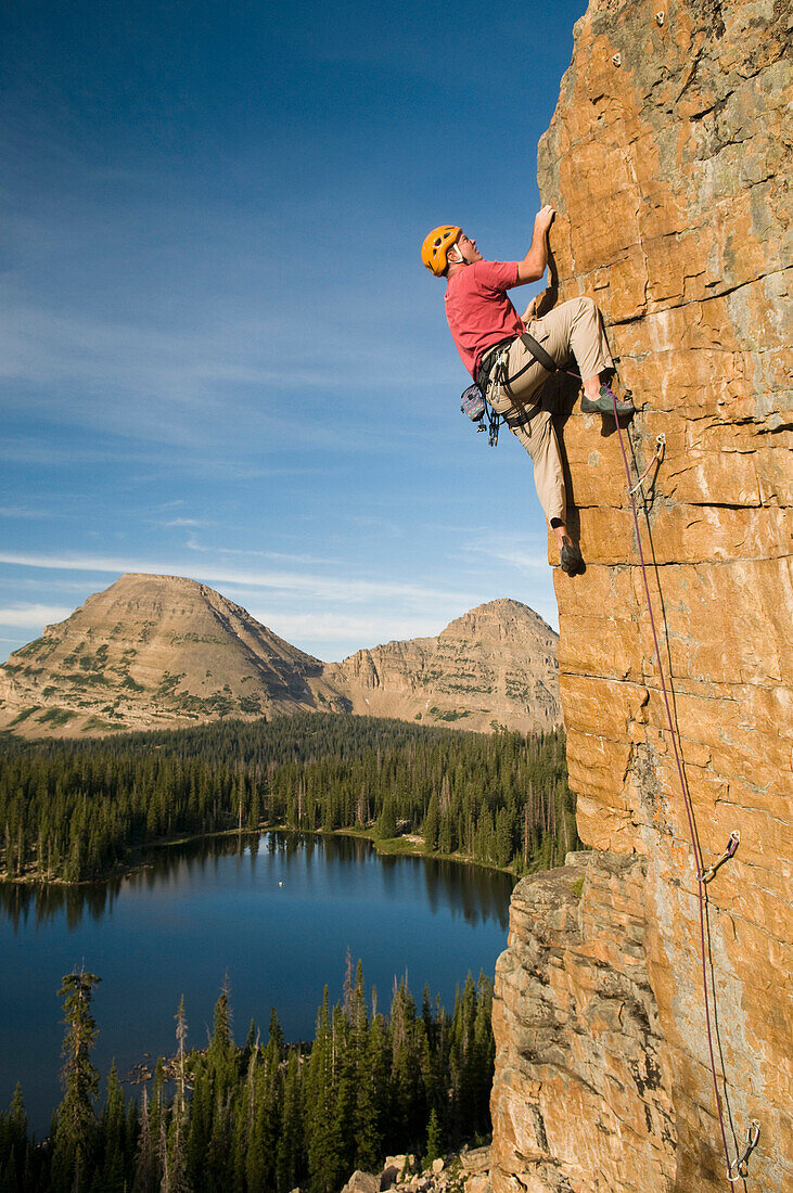 A man rock climbing above Scout Lake, Uinta Mountains, Francis, Utah Francis, Utah, USA