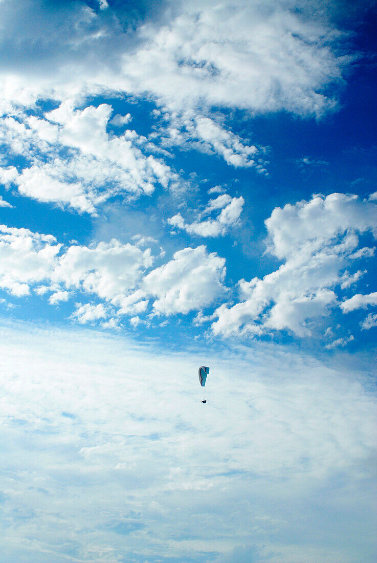 Hang glider flies in the clouds over San Diego, California San DIego, California, USA
