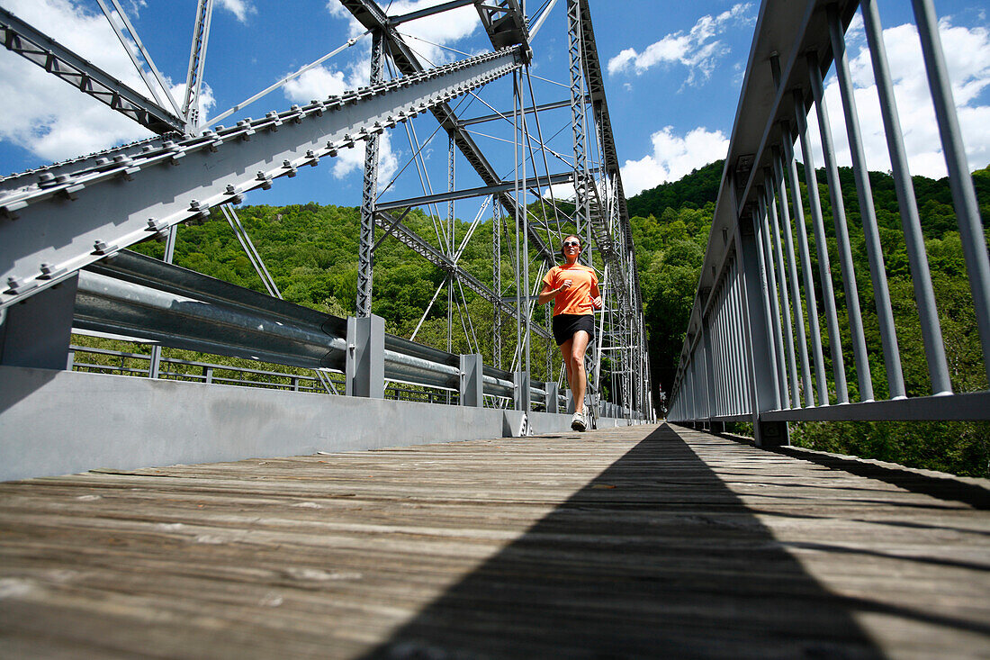 Woman runs across a steel bridge Fayetteville, West Virginia, USA