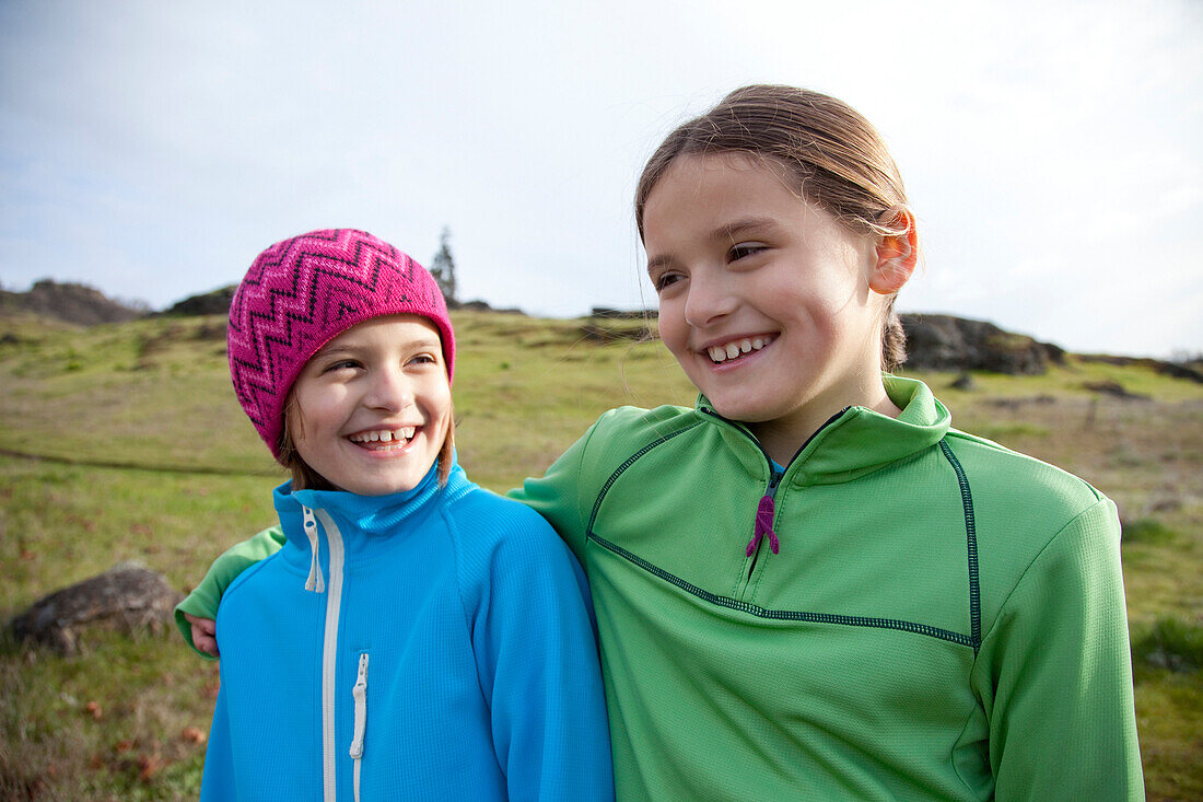 Portrait of two young girls smiling while out hiking White Salmon, Washington, USA
