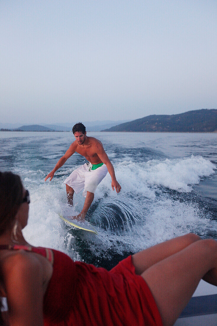 Young man wakesurfing in Idaho Sandpoint, Idaho, USA