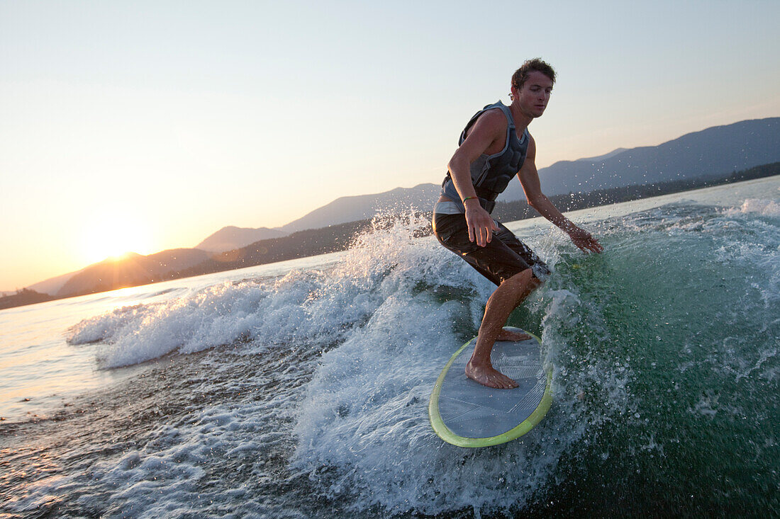 Young man wakesurfing in Idaho Sandpoint, Idaho, USA