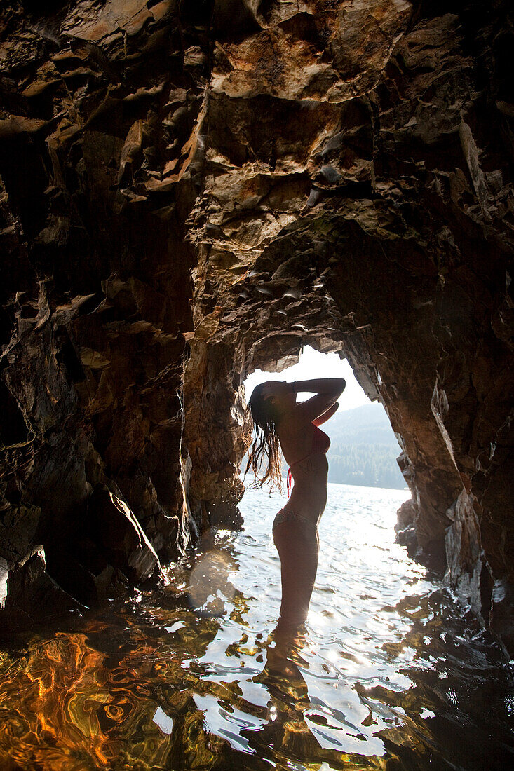 Female body silhouetted against cave in Idaho Sandpoint, Idaho, USA