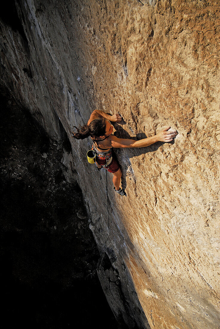 A rock climber ascends a steep rock face in Mexico El Potrero Chico, Nuevo Leon, Mexico