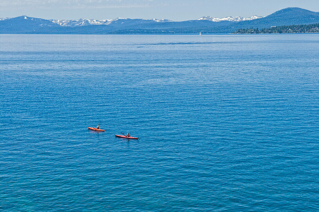 A pair of kayakers is out for a morning paddle on the pristine water of Lake Tahoe, Nevada Incline Village, Nevada, USA
