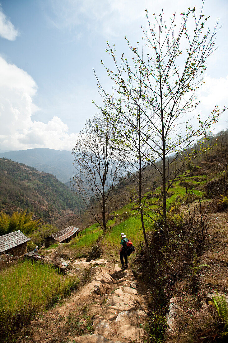 A lone trekker descends into a Nepalese village Solukhumbu Region, Nepal