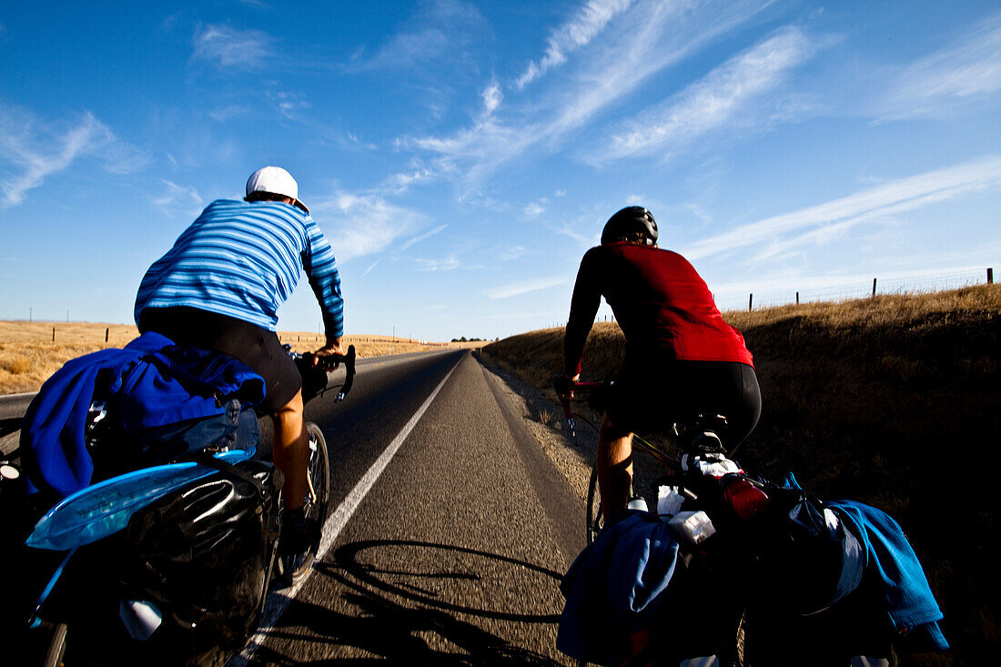 Two male cyclists ride Highway 65 outside of Porterville, California Porterville, California, United States of America