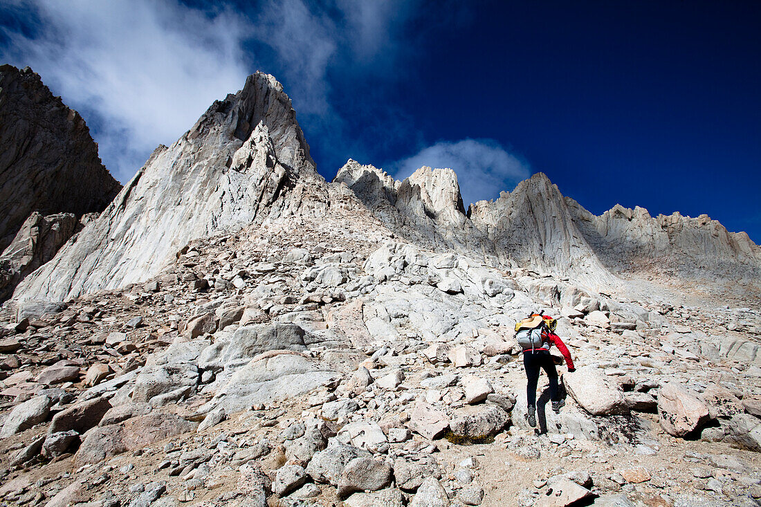 A female hiker scrambles up the mountaineer's route of Mount Whitney, California Lone Pine, California, United States of America