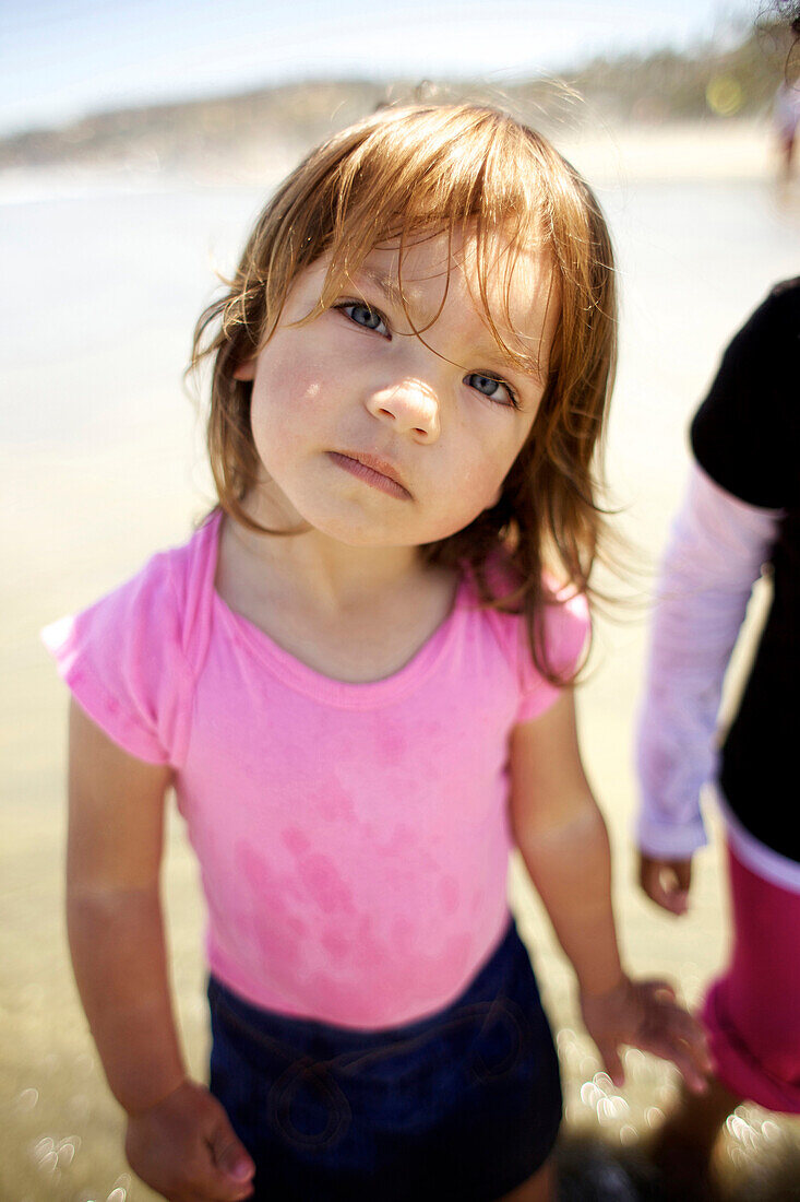 Young girl wearing pink looks at the camera curiously San Diego, CA, USA